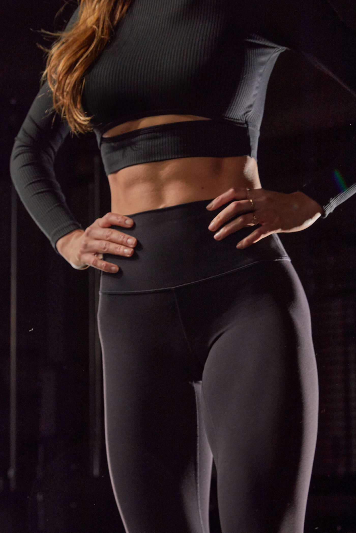 Woman in TONALift leggings with her hands on her hips in the gym